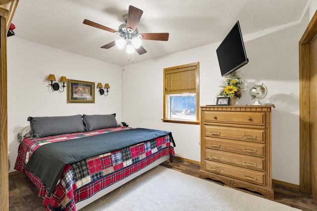 bedroom featuring ceiling fan, hardwood / wood-style flooring, and a textured ceiling