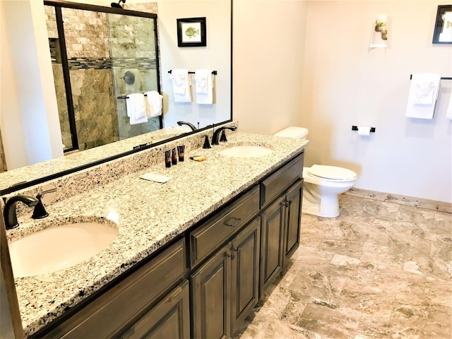 bathroom with vanity, toilet, and a shower with door