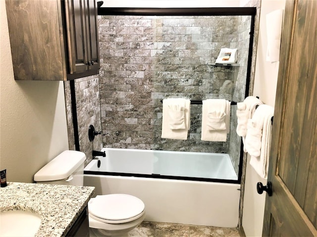 full bathroom featuring vanity, shower / bath combination with glass door, and toilet