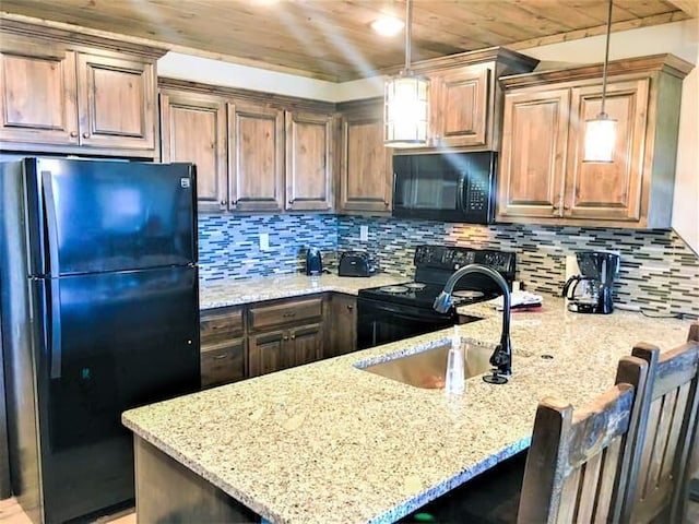 kitchen with wood ceiling, black appliances, pendant lighting, and a kitchen breakfast bar