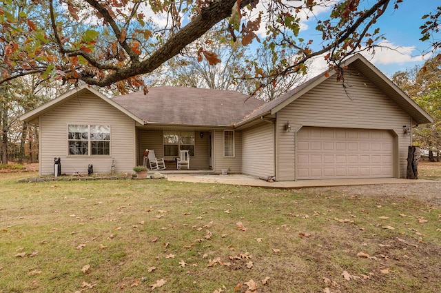 ranch-style house with a garage and a front lawn