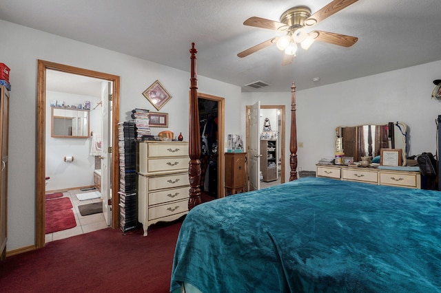 carpeted bedroom featuring a closet, connected bathroom, a walk in closet, and ceiling fan