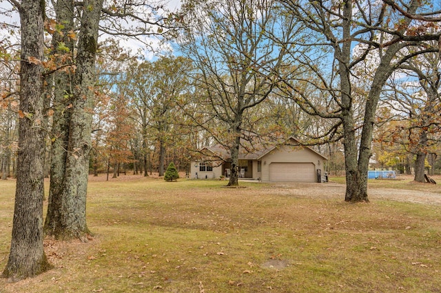 view of front of home featuring a front lawn and a garage