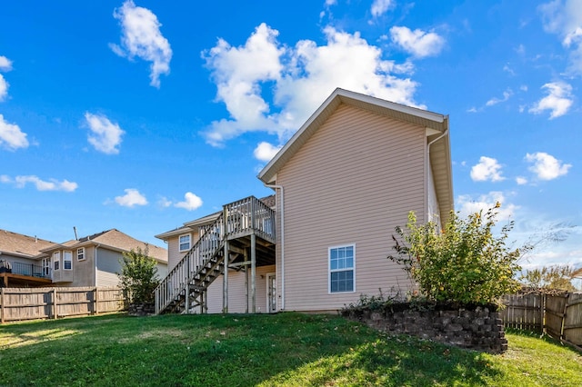 back of house featuring a yard and a deck