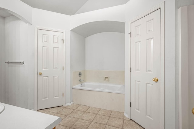 bathroom with a bathing tub and tile patterned flooring