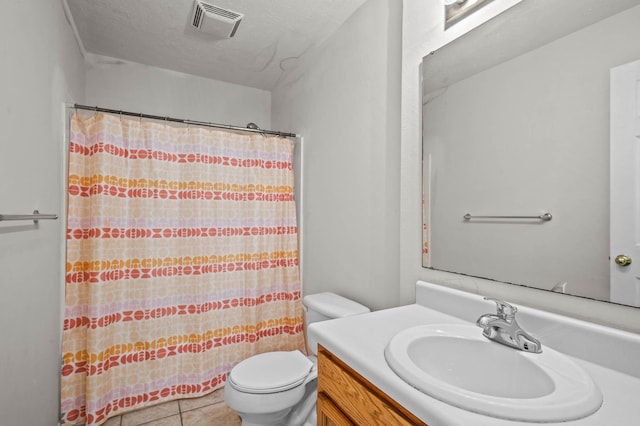 bathroom featuring a textured ceiling, toilet, vanity, curtained shower, and tile patterned flooring