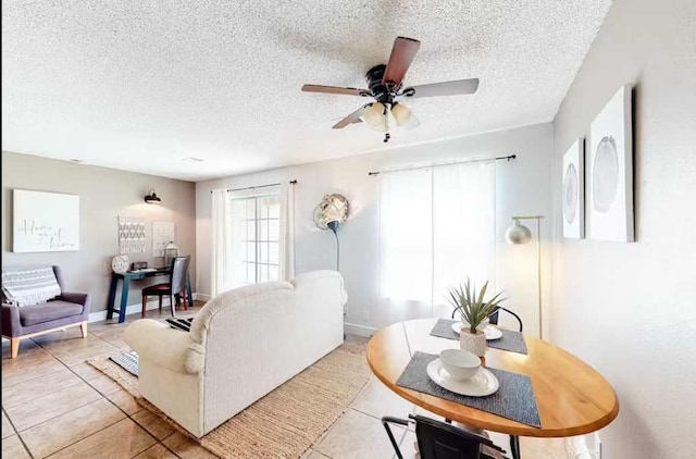 living room with a textured ceiling, light tile patterned floors, and ceiling fan