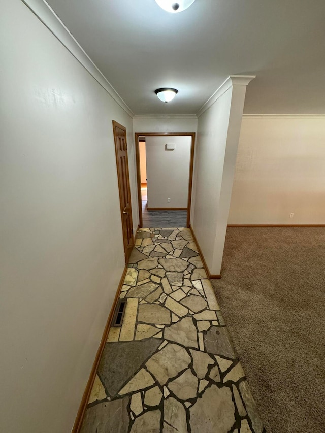 hallway featuring crown molding and carpet