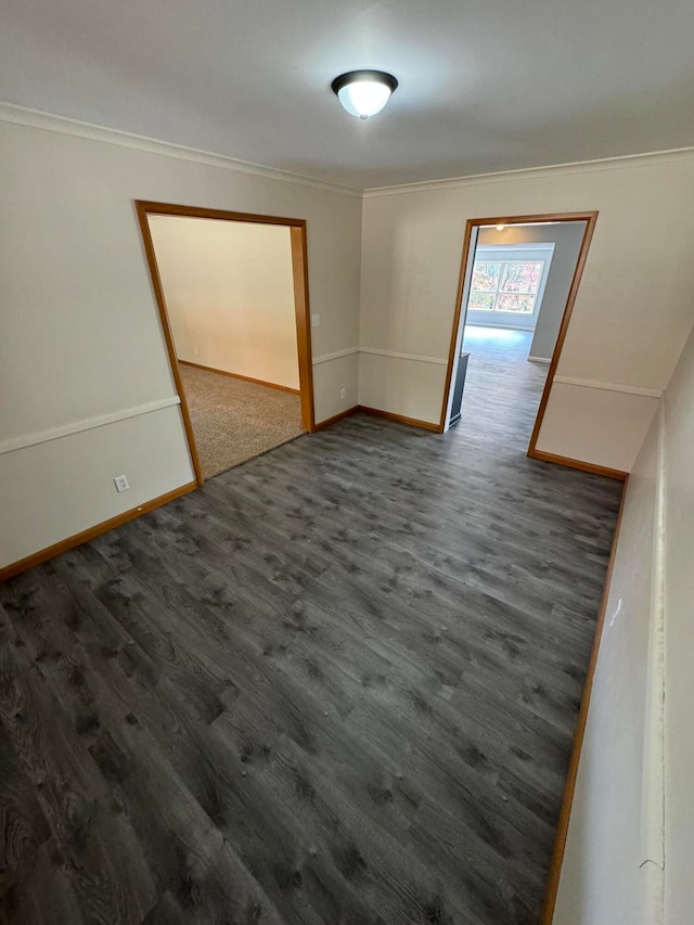 unfurnished room with crown molding and dark hardwood / wood-style flooring