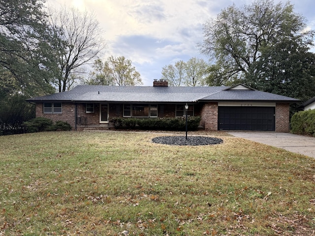 2734 E Glenwood St, Springfield, MO 65804 - ranch-style house with a chimney, brick siding, an attached garage, concrete driveway, and a front yard