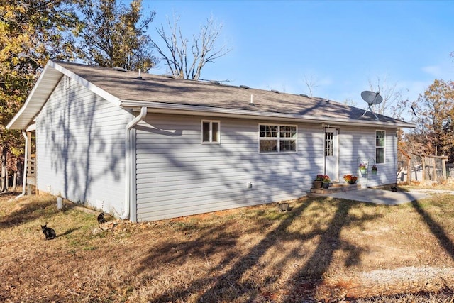 rear view of house with a patio area and a lawn