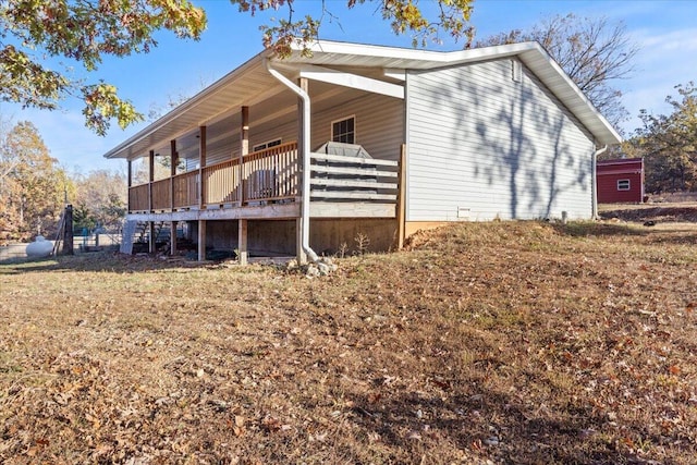 view of side of property featuring a wooden deck