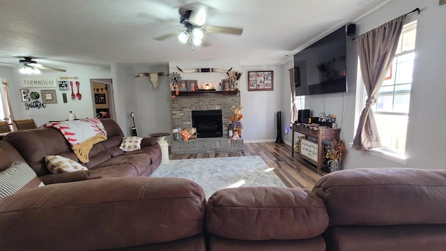 living room with a fireplace, hardwood / wood-style flooring, and ceiling fan