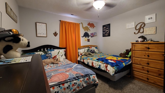 bedroom featuring a textured ceiling, carpet floors, and ceiling fan