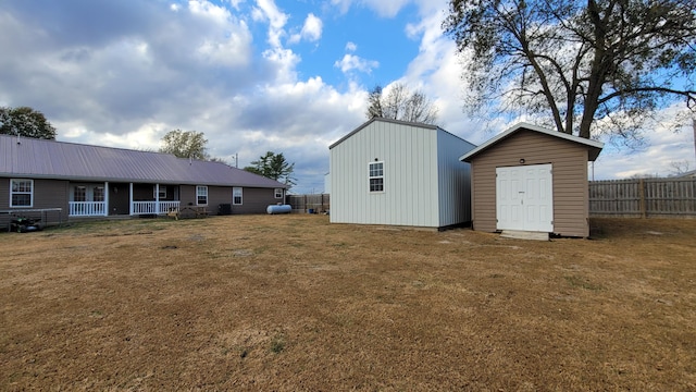 exterior space featuring covered porch and a shed