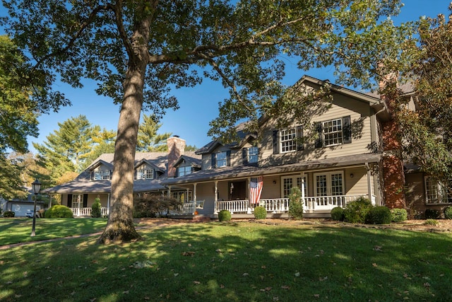 view of front of house with covered porch and a front lawn