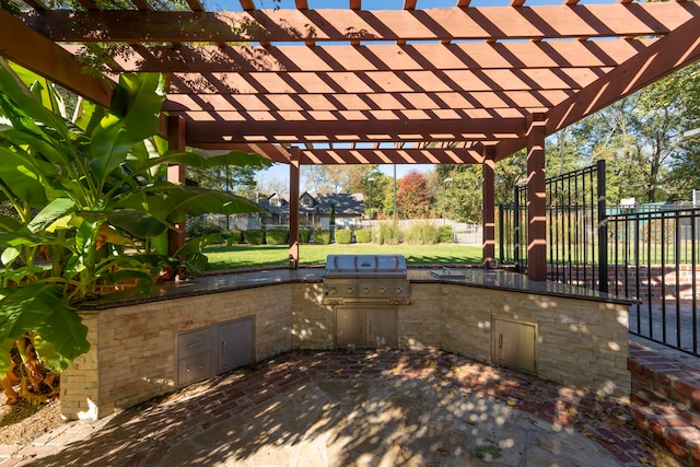 view of patio with exterior kitchen, a pergola, and area for grilling