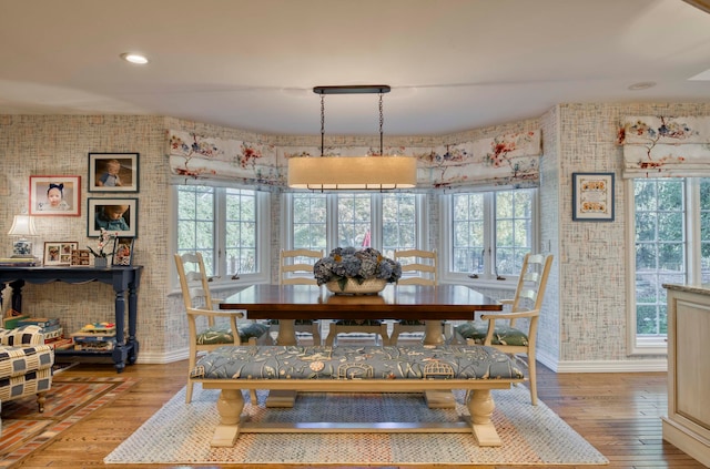 dining area with a wealth of natural light and wood-type flooring