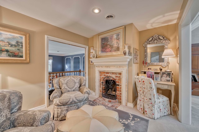 sitting room featuring light carpet and a fireplace