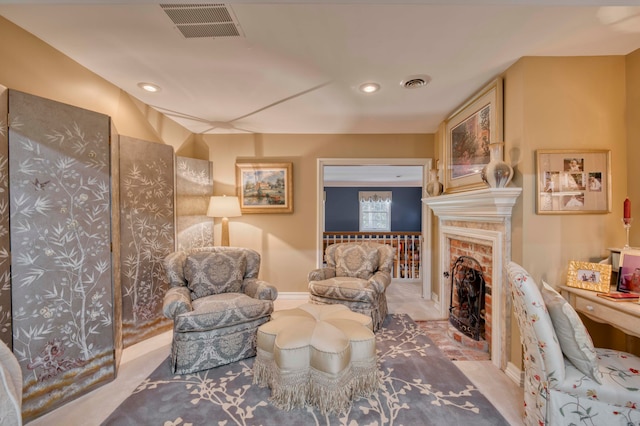 sitting room featuring carpet flooring and a fireplace