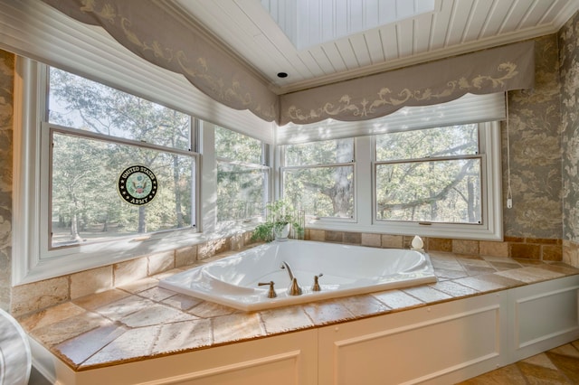 bathroom featuring a washtub and a skylight