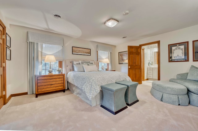 carpeted bedroom featuring ensuite bathroom