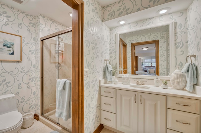 bathroom featuring tile patterned floors, vanity, toilet, and an enclosed shower