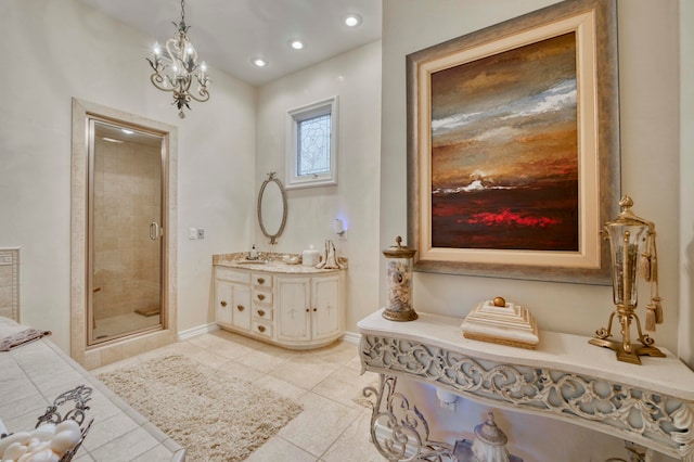 bathroom featuring a notable chandelier, vanity, tile patterned flooring, and a shower with shower door