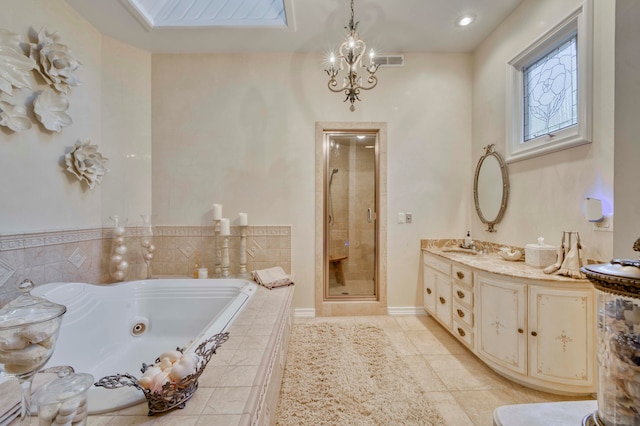 bathroom featuring tile patterned flooring, a skylight, a chandelier, vanity, and plus walk in shower