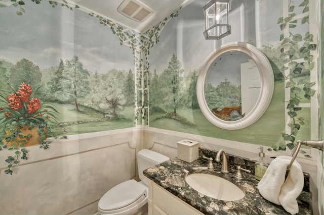 bathroom featuring toilet and vanity