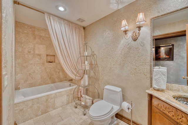 full bathroom featuring shower / bath combo with shower curtain, vanity, and toilet