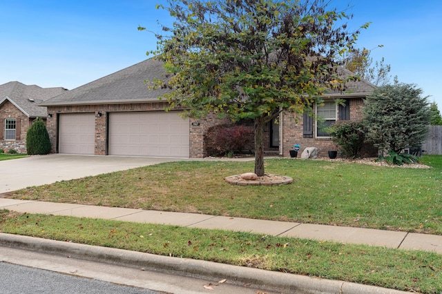 view of property hidden behind natural elements featuring a front lawn and a garage