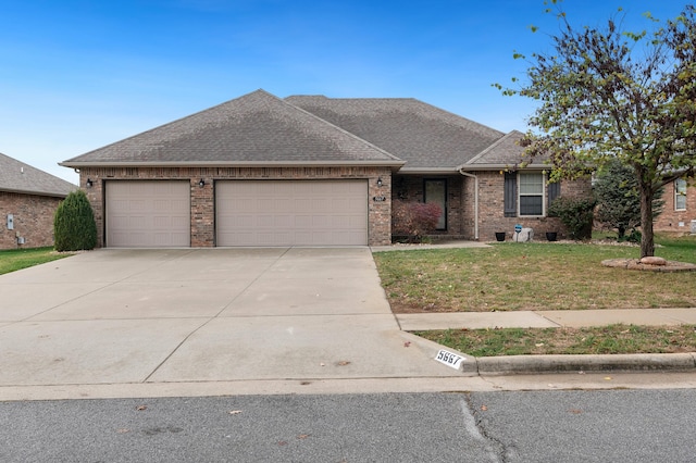 ranch-style house featuring a front yard and a garage