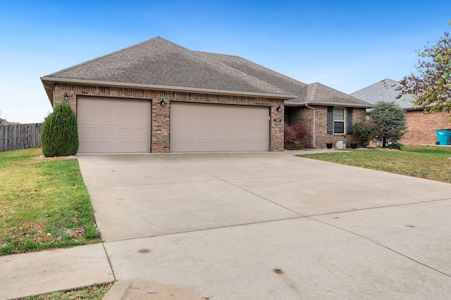 ranch-style home with a front lawn and a garage