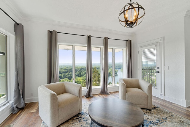 sitting room with a notable chandelier, a healthy amount of sunlight, and light hardwood / wood-style flooring