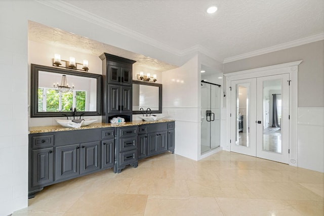 bathroom with a textured ceiling, walk in shower, tile walls, ornamental molding, and vanity