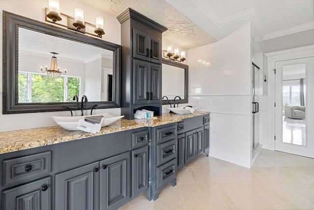 bathroom with a textured ceiling, walk in shower, a chandelier, vanity, and crown molding