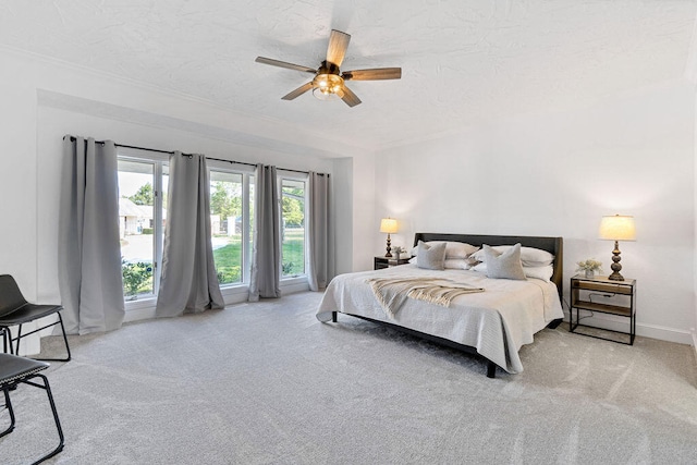 carpeted bedroom with a textured ceiling and ceiling fan