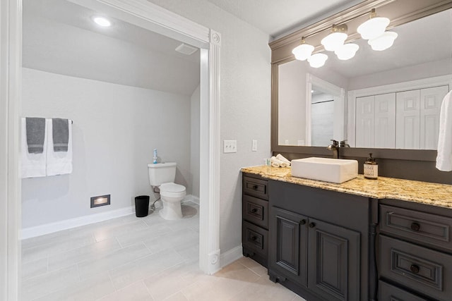 bathroom with vanity, toilet, and tile patterned floors