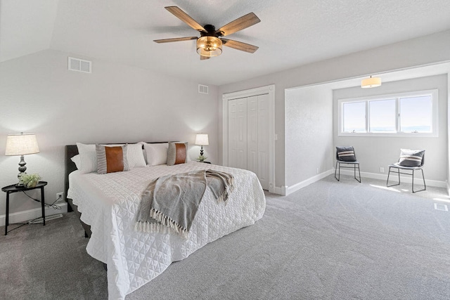 bedroom featuring lofted ceiling, carpet floors, a closet, and ceiling fan