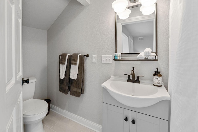 bathroom featuring vanity, toilet, and tile patterned flooring