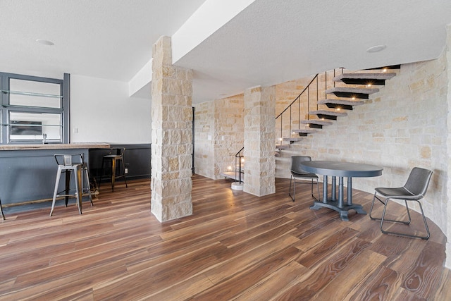 interior space featuring a textured ceiling and dark hardwood / wood-style flooring