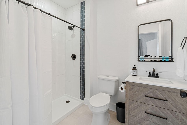 bathroom with vanity, walk in shower, toilet, and tile patterned floors