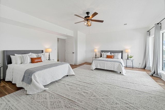 bedroom with ceiling fan and hardwood / wood-style flooring