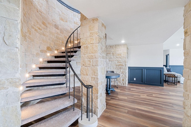 stairs featuring hardwood / wood-style floors