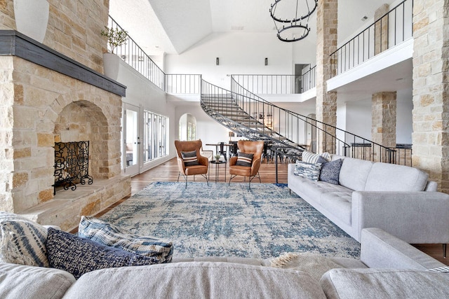 living room with high vaulted ceiling and wood-type flooring