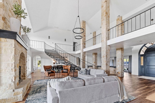 living room featuring hardwood / wood-style flooring, high vaulted ceiling, and a wealth of natural light