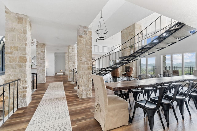 dining room featuring hardwood / wood-style floors and decorative columns