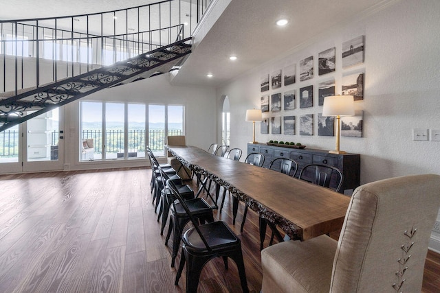 dining room featuring ornamental molding, hardwood / wood-style floors, and a healthy amount of sunlight