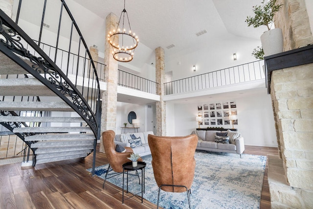 living room with hardwood / wood-style flooring and high vaulted ceiling